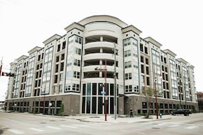 A multi-story residential building with a curved facade, large windows, and a central entrance. - Downtown Houston Skyline Stay, Steps to Daikin Park C (Houston)