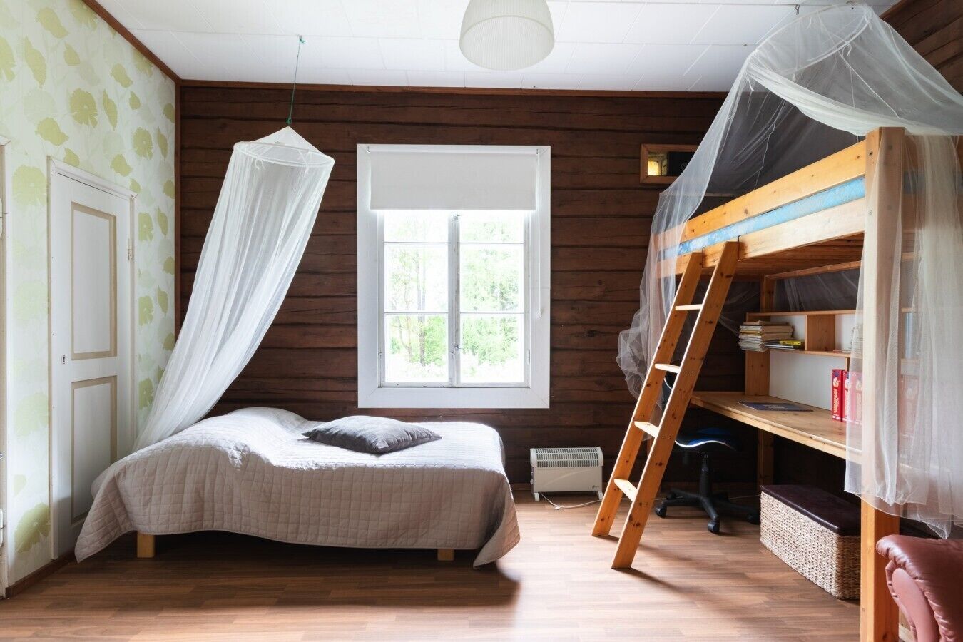 A bedroom with a bed, a window, a ladder, and a bunk bed.