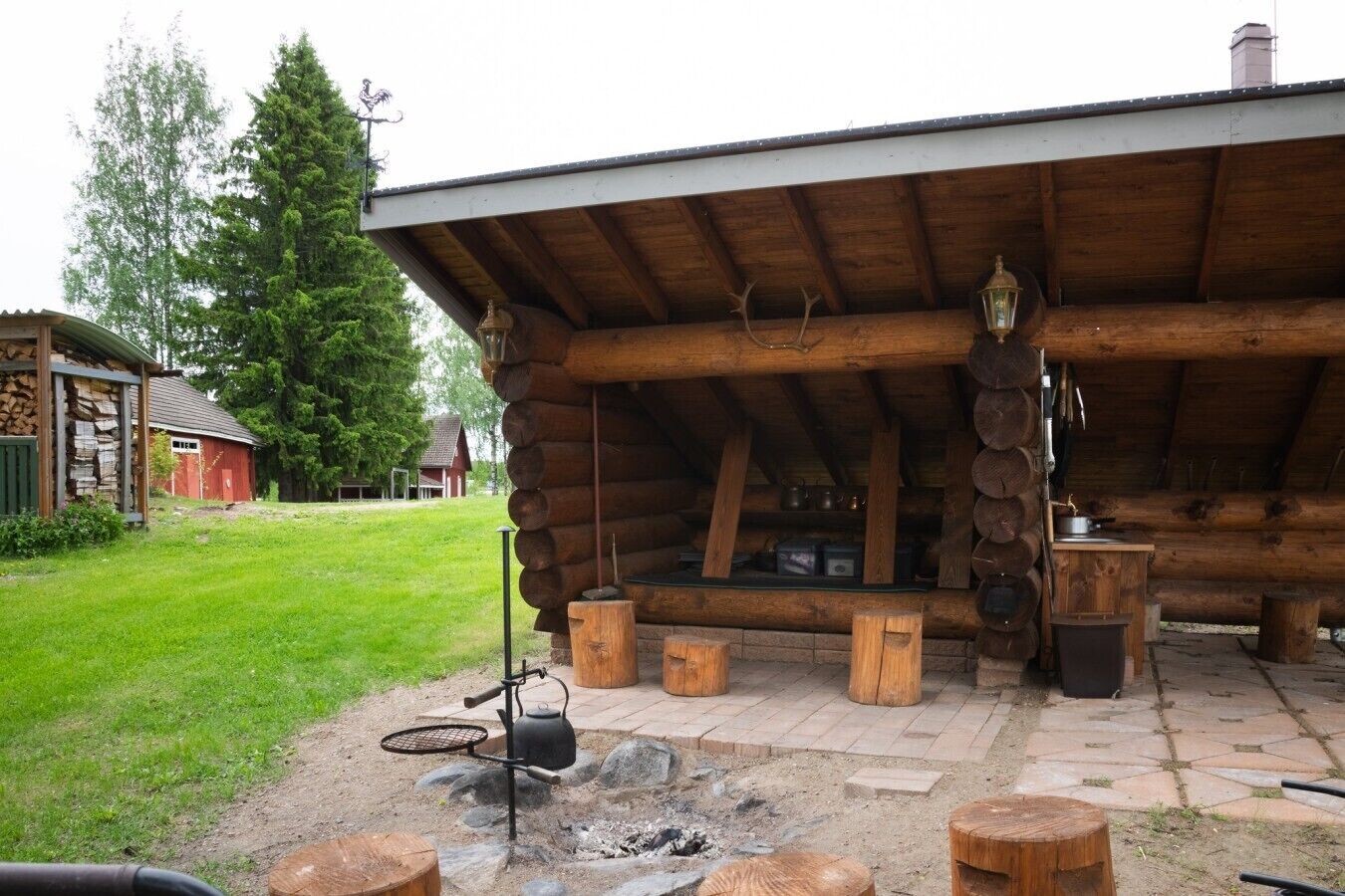 A rustic wooden cabin with a fire pit and outdoor seating.