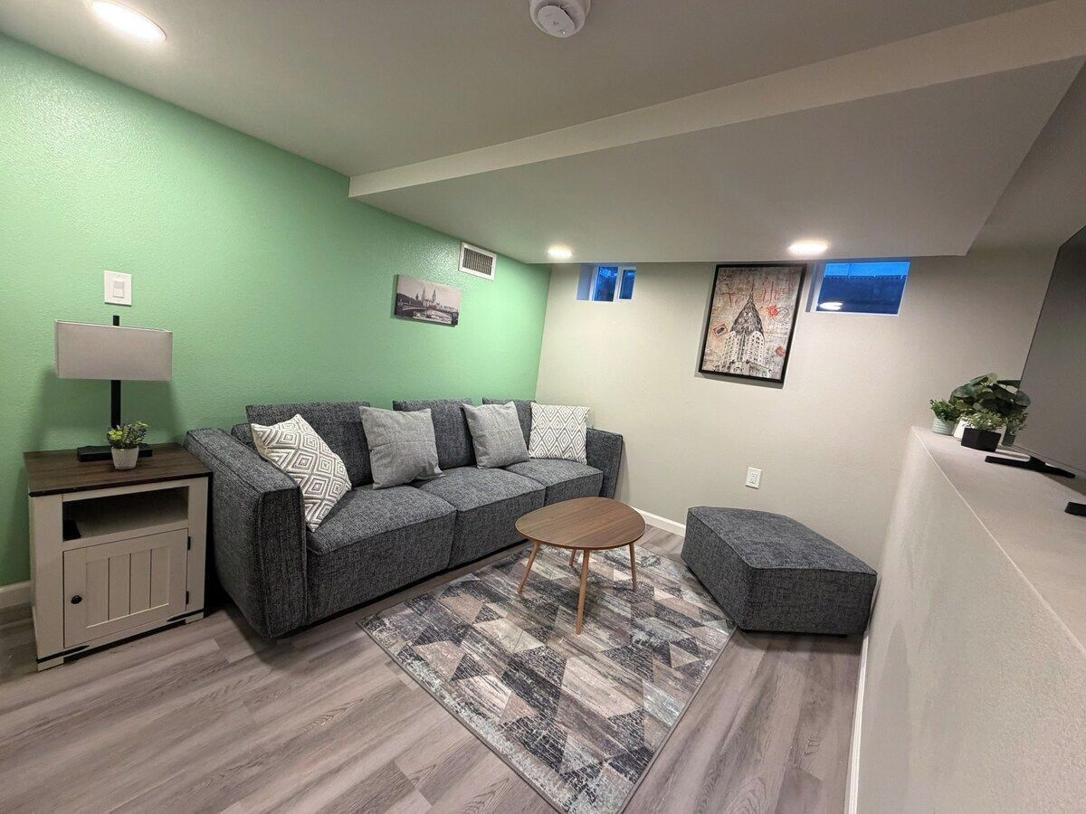 A living room with a sofa, a coffee table, a side table, and a rug.