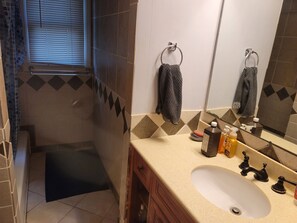 A bathroom with a sink, mirror, towel rack, and a window with blinds. - Charming 3-bedroom house, fenced backyard and AC in brilliant Overland Park (Overland Park)