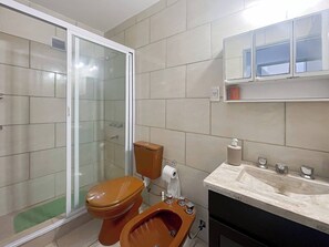 A bathroom with a glass-enclosed shower, a toilet, a bidet, and a sink with a mirror above. - Beautiful 2 Bedrooms in the Heart of Palermo (Buenos Aires)