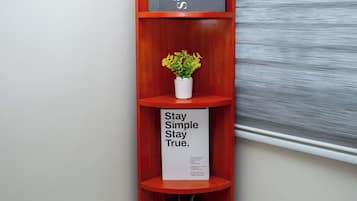 A corner shelf unit with multiple shelves, each holding decorative items.