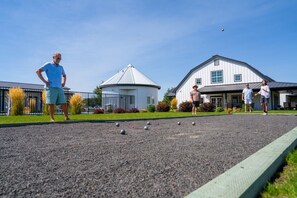 A croquet court with a building in the background.