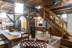 A rustic interior with a wooden staircase, dining area, and kitchen. - Large House 250m From the Beach Rnh0038 (Bombinhas)