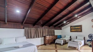 A hotel room with a high ceiling, wooden beams, a bed, a desk, and a small table. - House With Private Pool Near the Beach Rox0325 (Bombinhas)
