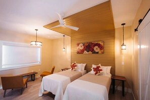 A hotel room with two beds, a desk, a chair, a ceiling fan, and a large window. - Tannin Suite at The Barn | Boutique Hotel (Walla Walla)