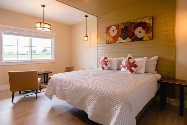A hotel room with a large bed, a desk, a chair, and a window. - Tannin Suite at The Barn | Boutique Hotel (Walla Walla)