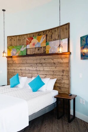A bed with a wooden headboard, a bedside table, and a hanging light fixture. - The Granary Suite at The Barn | Boutique Hotel (Walla Walla)
