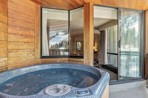 A wooden cabin with a hot tub, large windows, and a view of a snowy landscape. - Snowbird Cliff Club, Ski-in/out, Sleeps 10, Private Hot Tub - January 8-15, 2027 (Sandy)