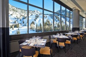 A restaurant with tables set for dining, large windows offering a view of a snowy mountain landscape. - Snowbird Cliff Club, Ski-in/out, Sleeps 10, Private Hot Tub - January 8-15, 2027 (Sandy)