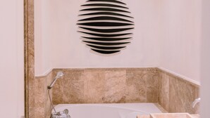 A modern bathroom with a freestanding bathtub, a shower, and a built-in sink. - Marina View 2BR Apartment  Cap Cana (Punta Cana)