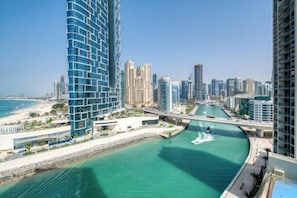 A coastal cityscape with high-rise buildings, a marina, and a bridge. - 52 42 Tower 1 (Dubai)