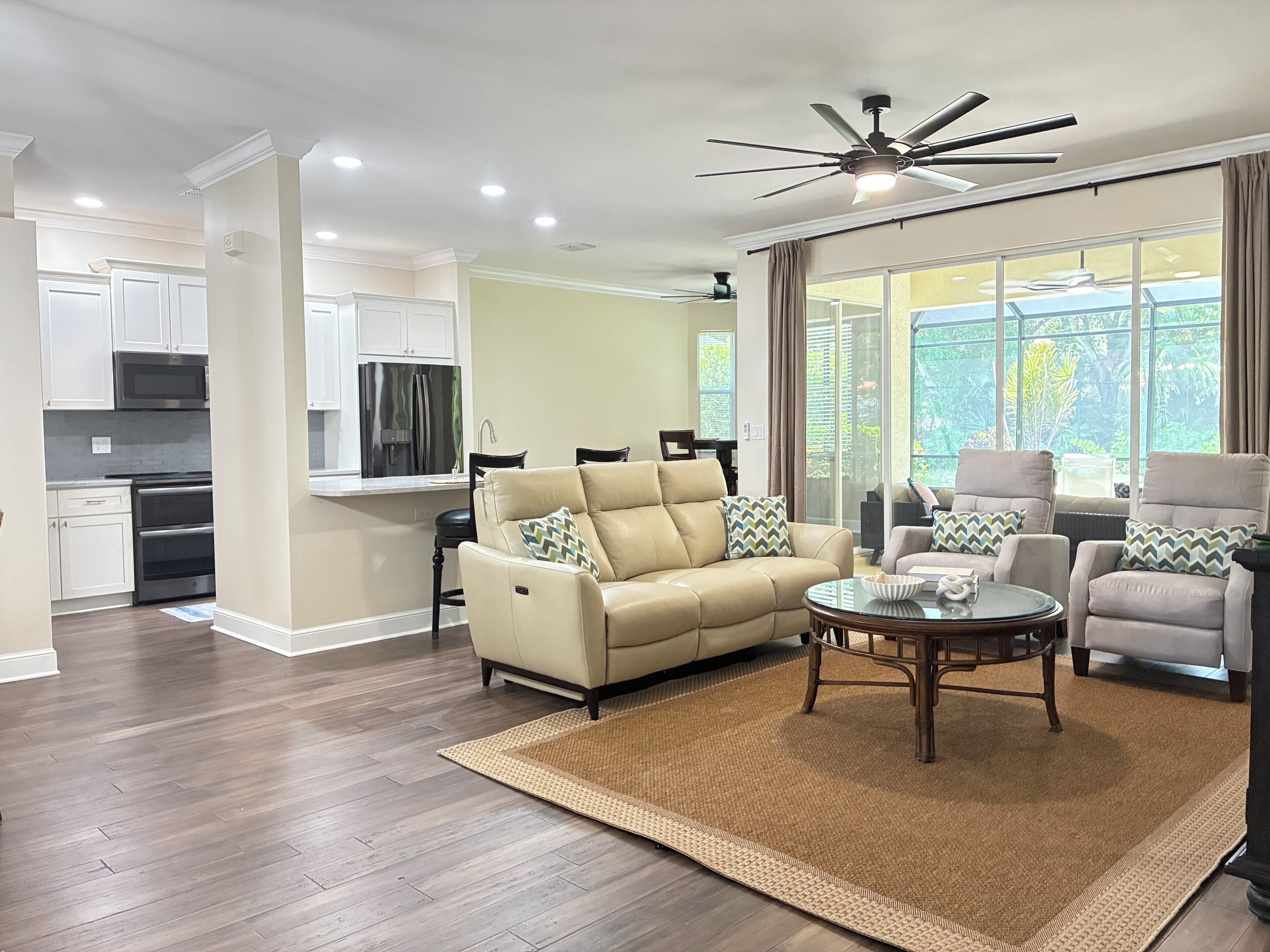 A modern living room with a sofa, armchairs, and a coffee table.