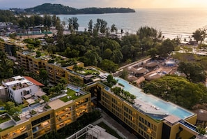 Een resort met meerdere gebouwen, een zwembad en uitzicht op zee.