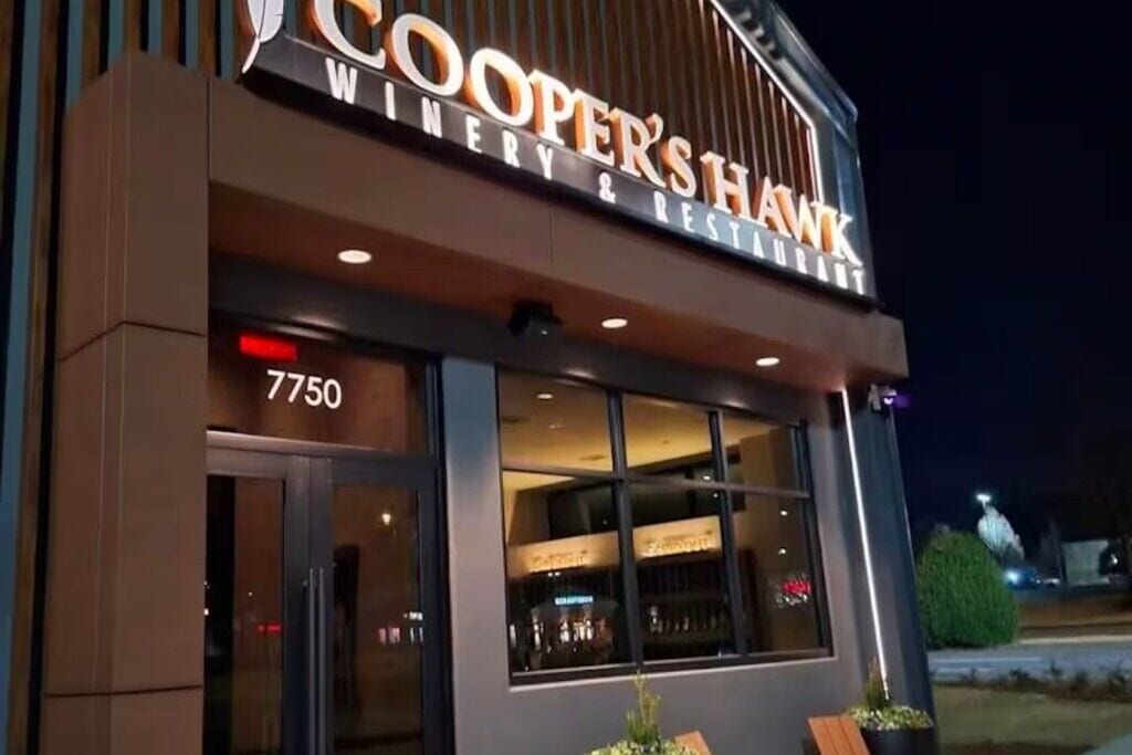 A building with a sign reading 'COOPER'S HAWK WINERY & RESTAURANT' and the address '7750'.