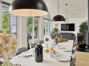 A modern dining area with a large table, chairs, and pendant lighting. - 16 Person Holiday Home in Albaek (Aalbaek)