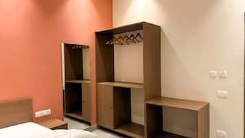 A bedroom with a bed, a wardrobe, and a bedside table.