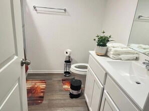 A bathroom with a toilet, sink, and a towel rack. - 5BR All One Level | Fenced Yard | Pet Friendly (Richmond)