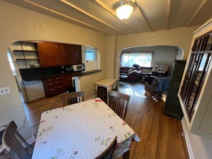 A compact living space with a kitchenette, dining area, and seating area.