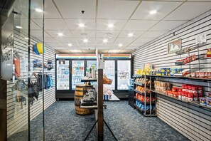 A grocery store interior with refrigerated sections, shelves stocked with snacks, and a display counter. - Village Peak 9 Inn Ski-in/Ski-out Walk to Main St (Breckenridge)