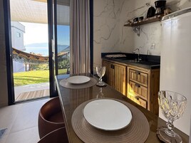 Una cocina moderna con comedor, ventanas amplias y vistas al exterior.