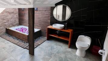 A bathroom with a bathtub, a sink, and a toilet.