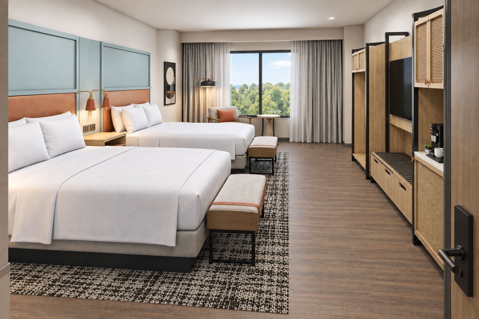A hotel room with two beds, a small table, a chair, a TV, and a large window with a view of trees.
