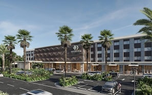 A modern hotel with a prominent 'DOUBLE TREE' sign, featuring a geometric facade and palm trees. - Doubletree By Hilton Punta Cana Downtown (Punta Cana)