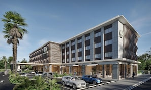 A modern hotel with a distinctive facade, multiple parking spaces, and a landscaped entrance. - Doubletree By Hilton Punta Cana Downtown (Punta Cana)