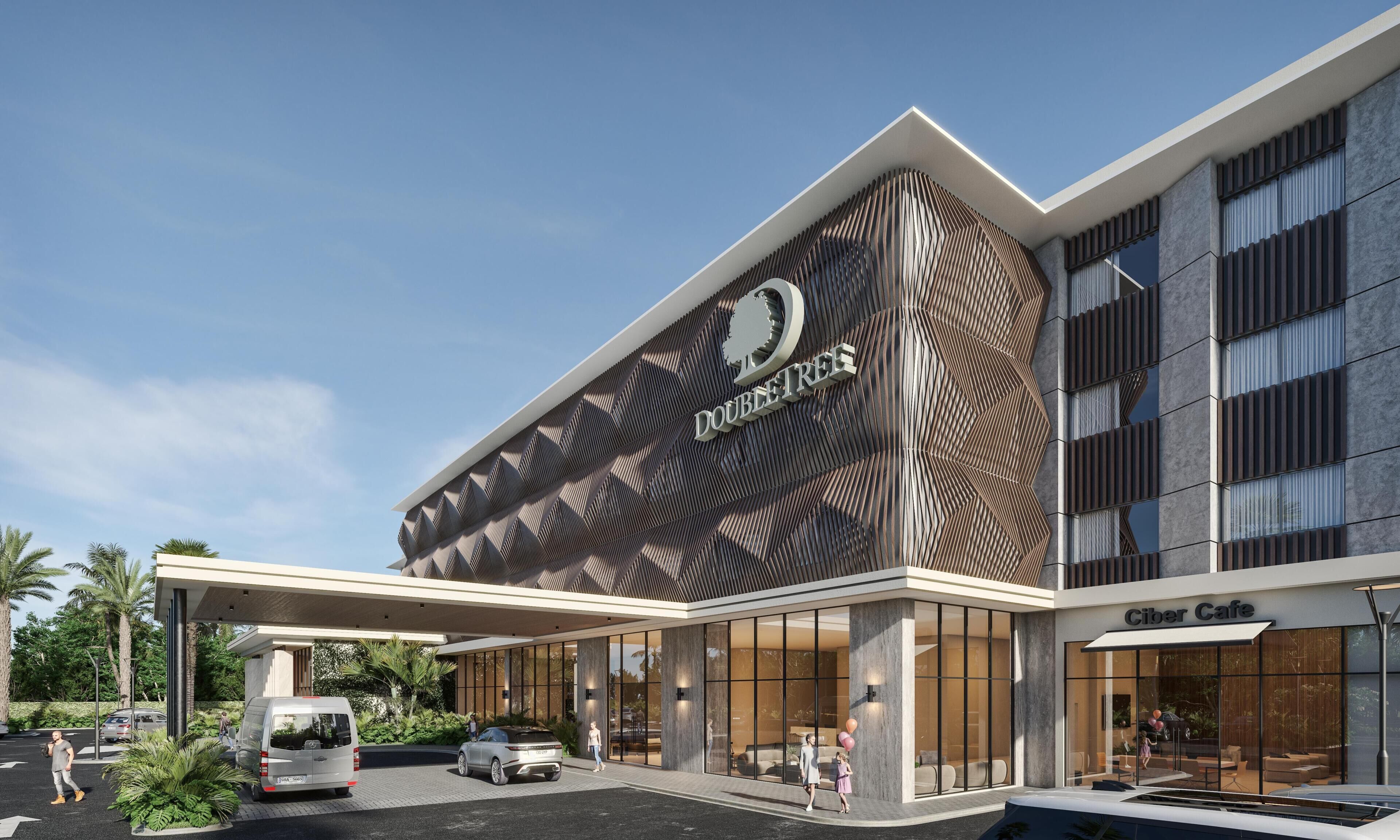 Un edificio moderno con una fachada distintiva que presenta un patrón geométrico y el nombre 'DOUBLETREE'.
