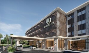 A modern building with a distinctive facade featuring a geometric pattern and the name 'DOUBLETREE'. - Doubletree By Hilton Punta Cana Downtown (Punta Cana)