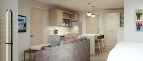 A modern hotel room with a kitchenette, a sofa, a dining area, and a bed.