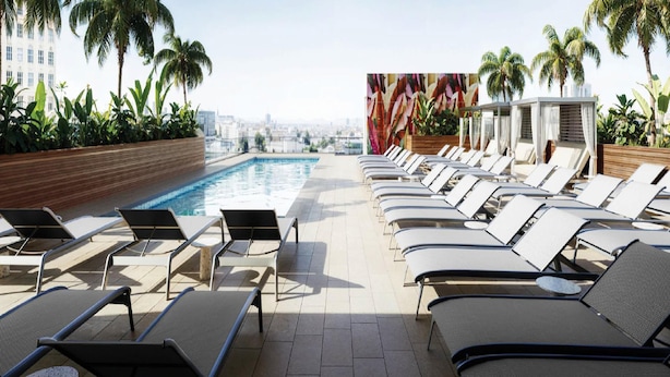 A rooftop pool area with lounge chairs and a city view. - Homewood Suites By Hilton San Juan (San Juan)