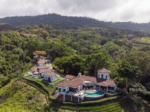 A large estate with multiple buildings, a swimming pool, and lush greenery. - Charming 3-bedroom estate in Osa • Private Pool • 180° Ocean View in Jungle (Puntarenas Province)