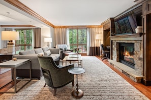 A spacious living room with a fireplace, comfortable seating, and large windows. - Luxury 2BR St. Regis Aspen Condo with Concierge & Housekeeping (Aspen)