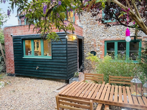 Charming Norfolk brick and flint cottage, with modern, cosy interiors.
