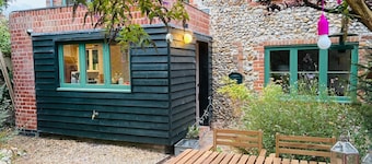 Charming Norfolk brick and flint cottage, with modern, cosy interiors.