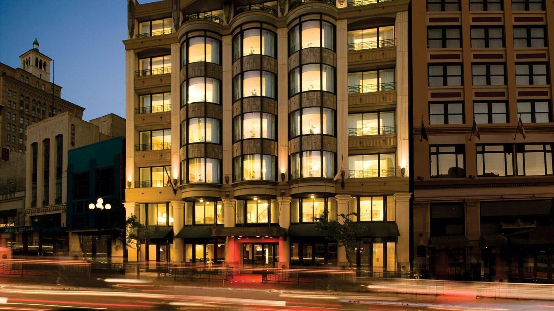A multi-story hotel with a classic architectural design, featuring large windows and a central entrance.