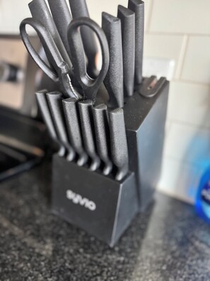 A kitchen utensil holder with various knives and scissors. - Skyline Views from the High-rise ! (Raleigh)