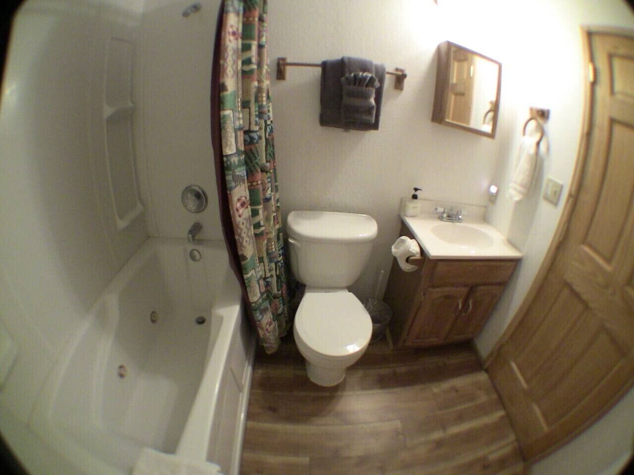 A bathroom with a bathtub, toilet, and sink.