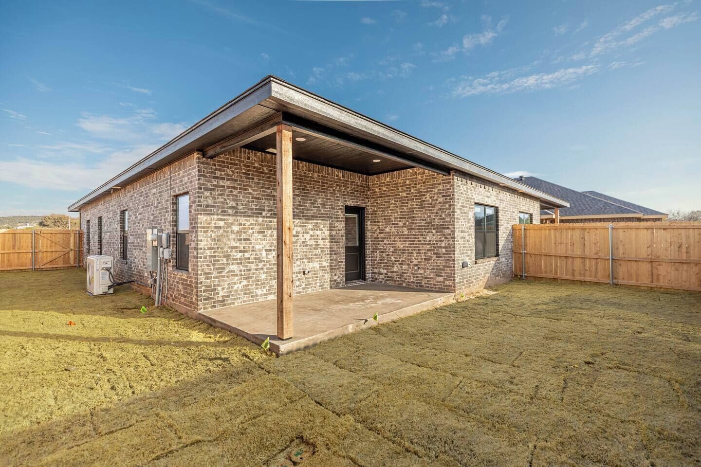 A single-story brick building with a covered patio area.