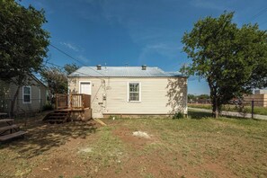 A single-story house with a front porch and a small deck. - Peaceful 2BR Home with Modern Comforts (Abilene)