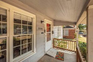 A residential property with a covered porch, a brick garage, and a number 3350 on the door. - Modern 3BR Home with Custom Wood Counters (Abilene)