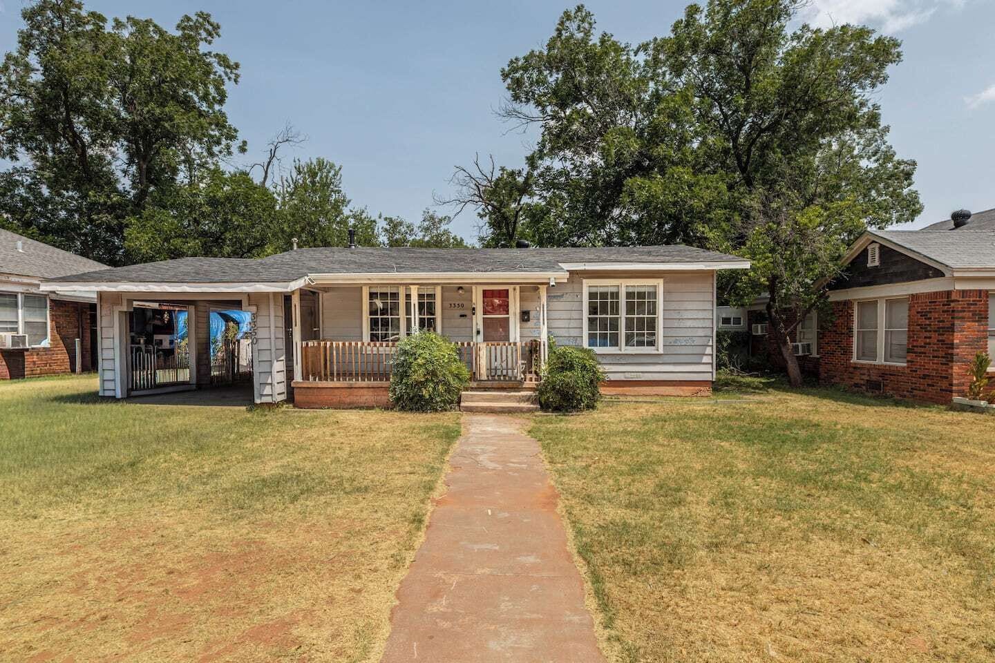 A single-story house with a front porch, a covered patio, and a visible garage.