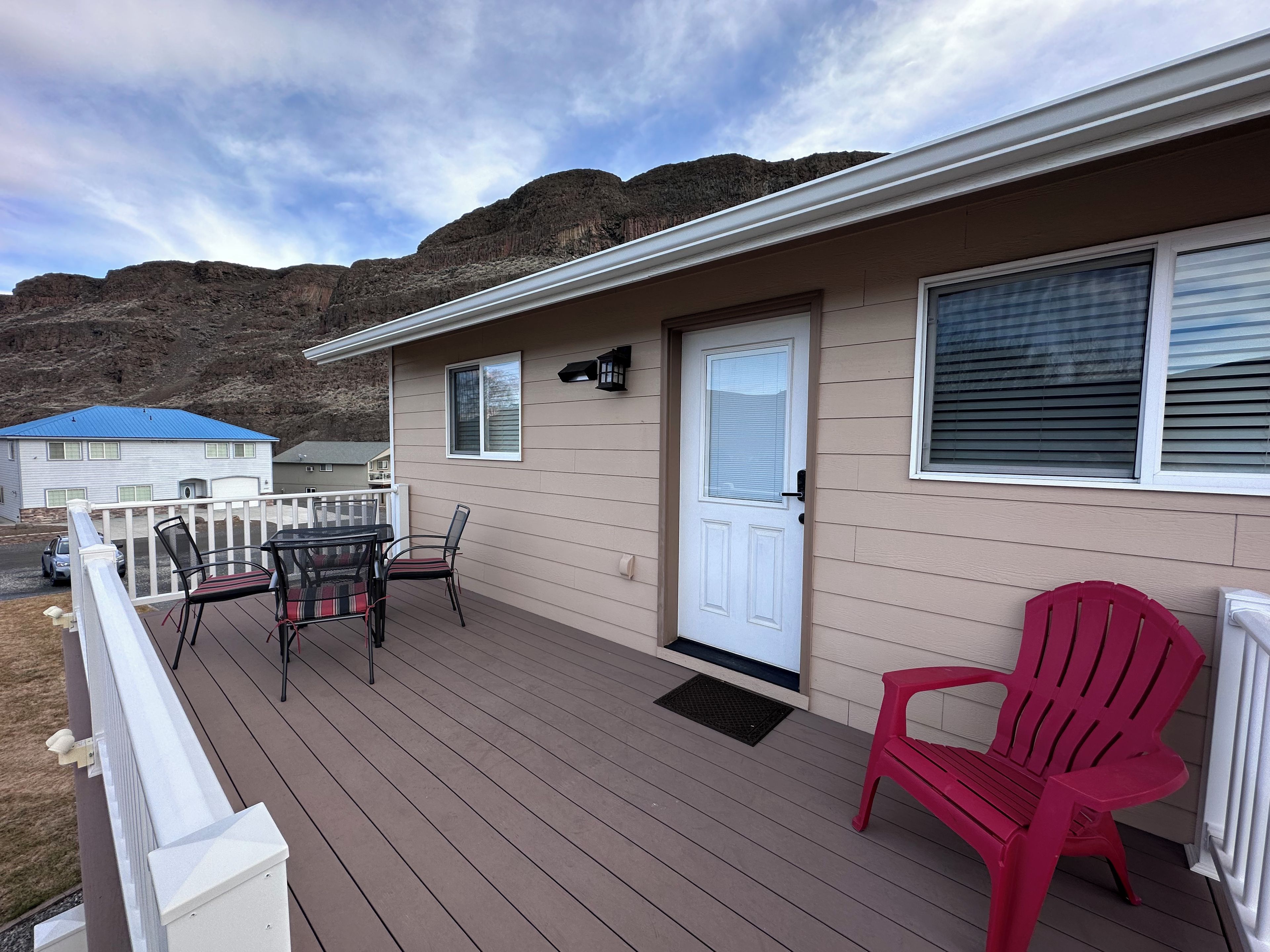 A single-story building with a deck, a door, and a window.
