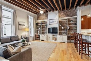 Living Room | Open Concept Living Area with TV, Exposed Beam Ceiling and Brick Wall | Third Floor of Building — Unit on One Level - Stylish CBD Loft , 5 min to French Quarter (New Orleans)