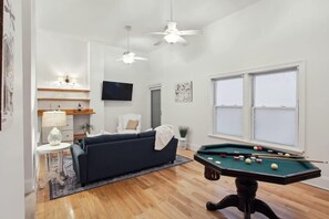 Den | Den with TV and Bumper Pool Table | Third Floor of Building — Unit on One Level - Stylish CBD Loft , 5 min to French Quarter (New Orleans)