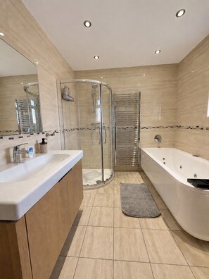 A modern bathroom with a glass-enclosed shower, a freestanding bathtub, and a vanity with a mirror. - Large 6 bedroom house in Oxford near John Radcliffe Hospital with parking for (Oxford)