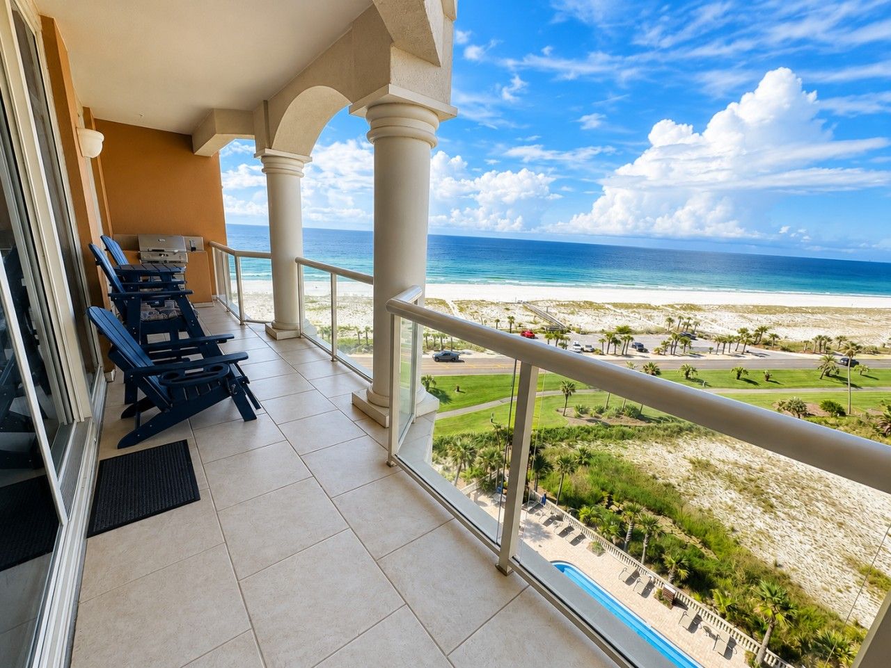 A balcony with a view of a beach and ocean.